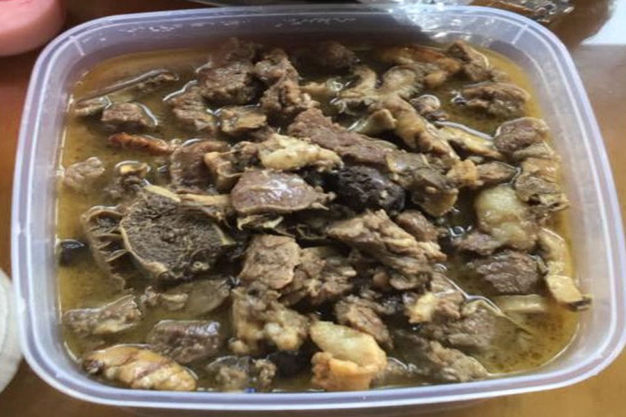A bowl of Papait, a traditional savory stew made from goat or beef innards with bitter bile, recognized as a unique Philippine exotic foods.