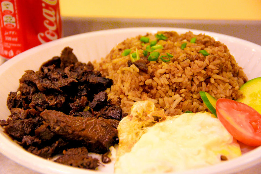 A plate of Tapsilog, featuring cured beef (tapa), garlic fried rice (sinangag), and a fried egg (itlog), a widely recognized combination of Philippine exotic foods.