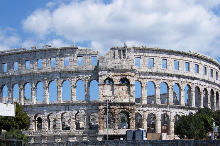Pula Arena in Croatia, an ancient Roman amphitheater, under a clear sky, symbolizing new global opportunities for Filipinos seeking DMW job Vacancies.