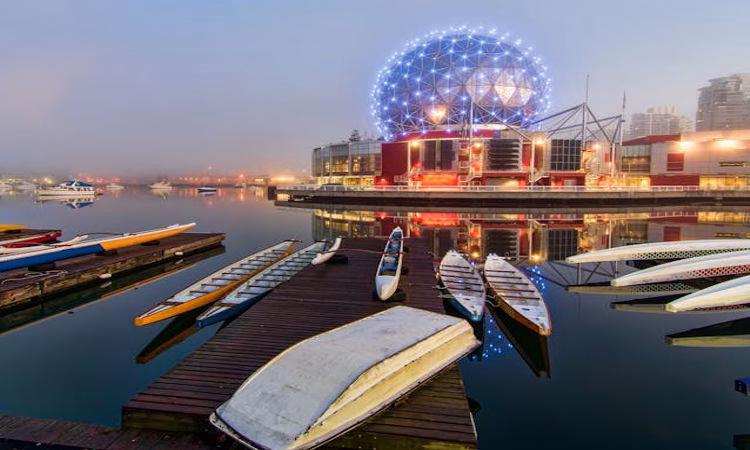 Vancouver harbor at night with a canoe and lights, symbolizing new beginnings and Philippine Jobs Canada opportunities.